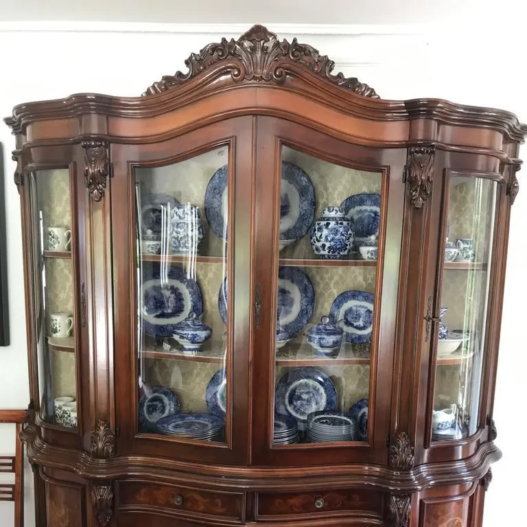 An ornate display cabinet filled with blue and white china